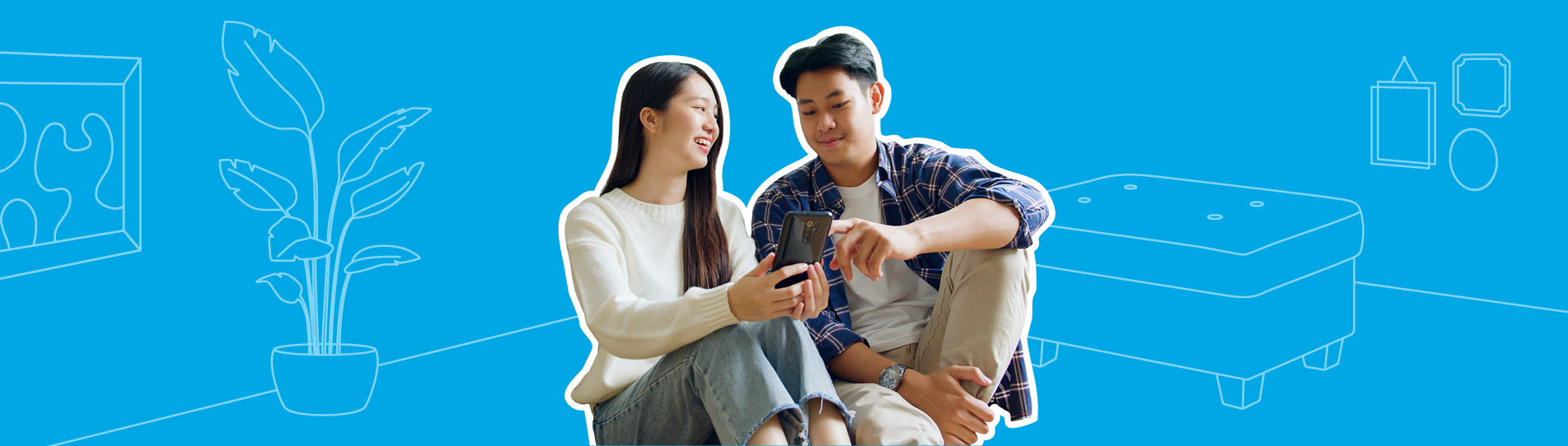 young couple sitting on the living room floor looking at their mobile phone